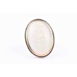 A mid to late 20th century yellow metal and opal cocktail ring, set with a large oval cabochon opal,