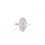 A diamond and platinum ring, in the Art Deco style, the lozenge-shaped mount centred with a collet-