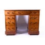 A Victorian mahogany pedestal desk, the leather inset top over three frieze drawers, and supported