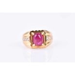 A yellow metal, diamond, and ruby ring, set with a cabochon ruby (treated), four-claw set in a