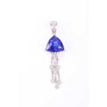 An 18ct white gold, diamond, and tanzanite pendant, set with a trillion-cut tanzanite of