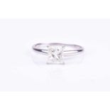 A princess-cut single stone diamond ringthe diamond approximately I/J colour, I1-2 clarity, four