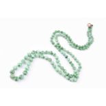 A Chinese green jadeite necklace, comprised of graduated round beads, measuring from 4mm - 9mm,