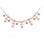 A yellow metal, pearl, and sapphire bib necklace, individually claw-set with round-cut sapphires and