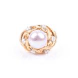 An 18ct yellow gold, diamond, and pearl cocktail ring, set with a round white cultured pearl,