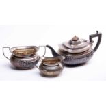 A matched early 20th century silver three-piece tea set, various dates and makers, with reeded