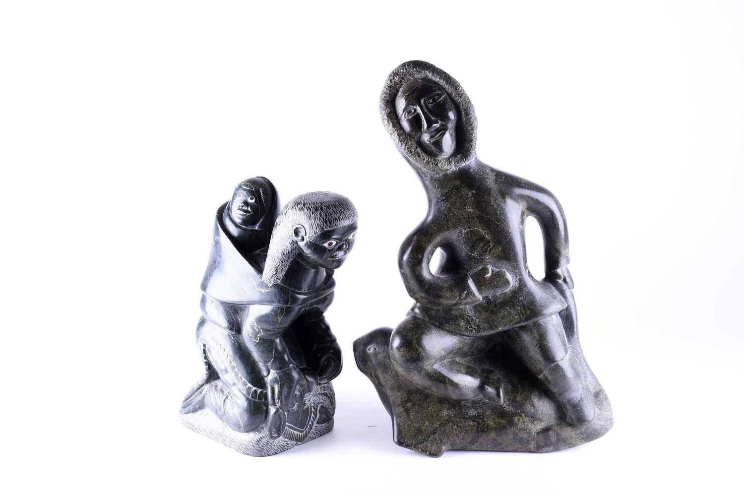 Two 20th century Alaska Inuit carved abstract figures, modelled as a mother with her child, finished