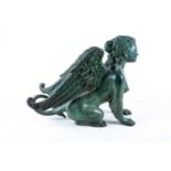 A patinated bronze of a winged sphinx, 20th century, seated on her haunches, with lion paw feet,