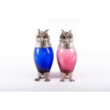 A pair of coloured glass owl decanters, realistically modelled with chrome plated head, feet and