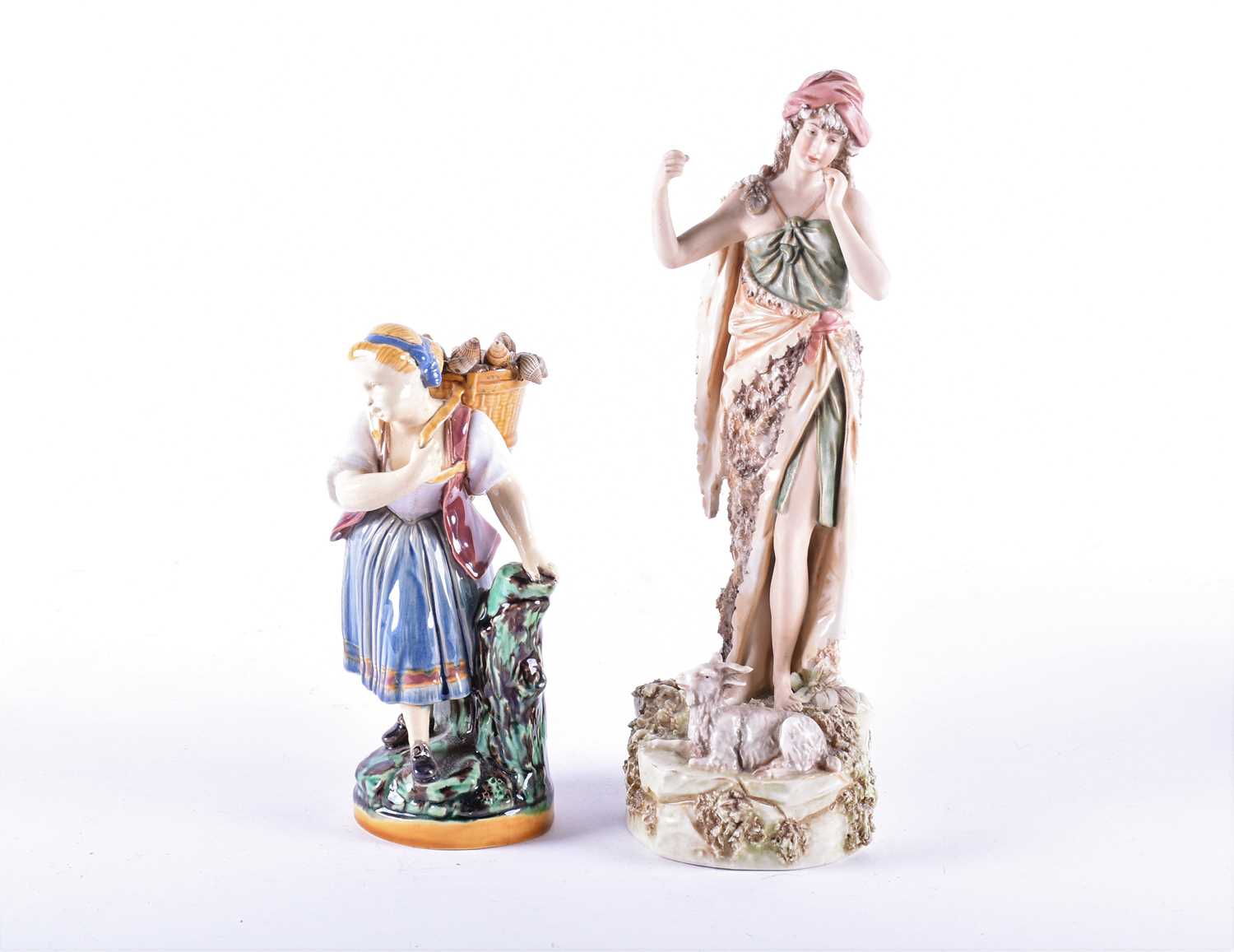 A Royal Dux porcelain figure of a shepherdess, a sheep at her feet, on a naturalistic base, numbered