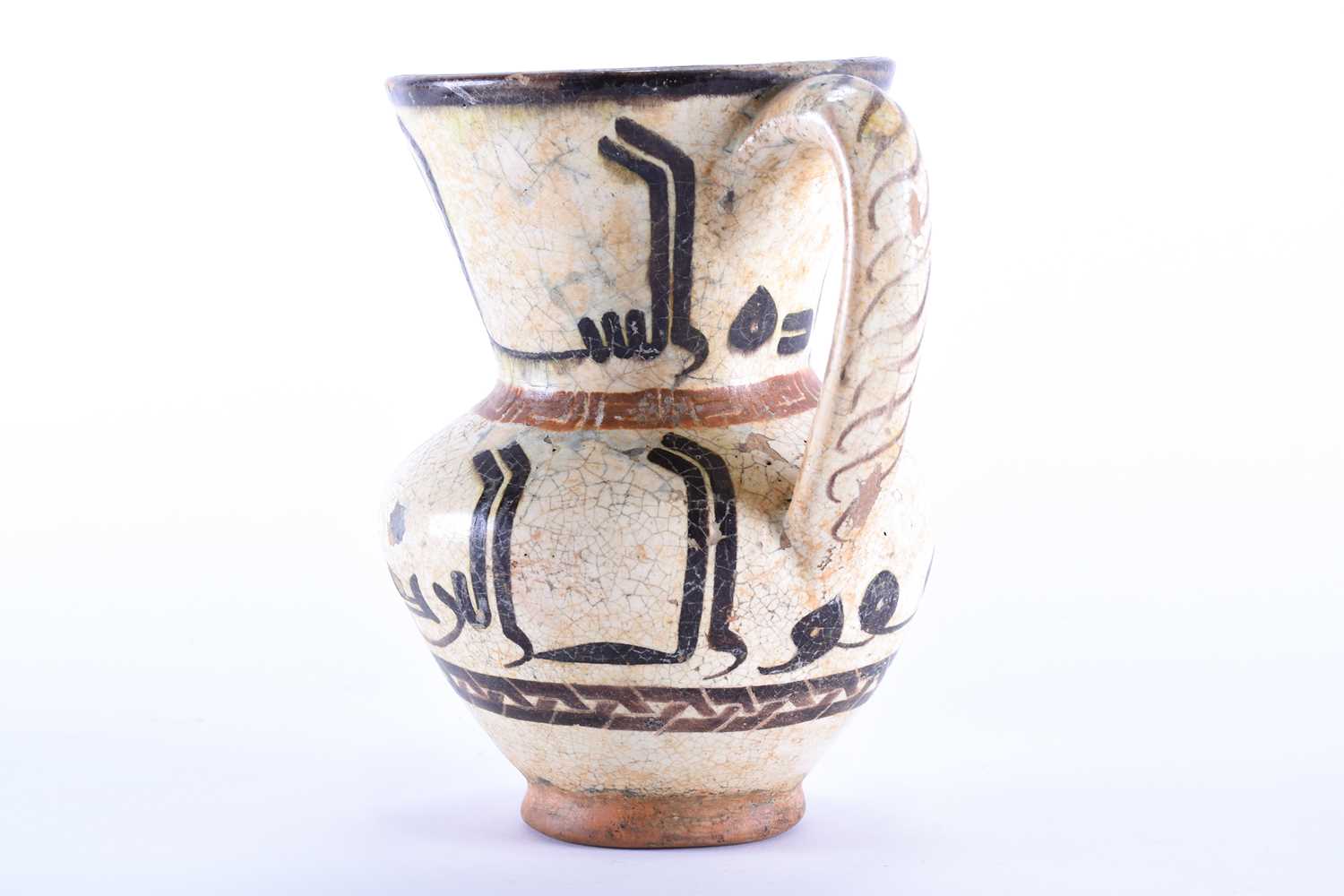 An early Islamic tin glazed ewer, with silhouette style calligraphic decoration between key and - Image 2 of 5