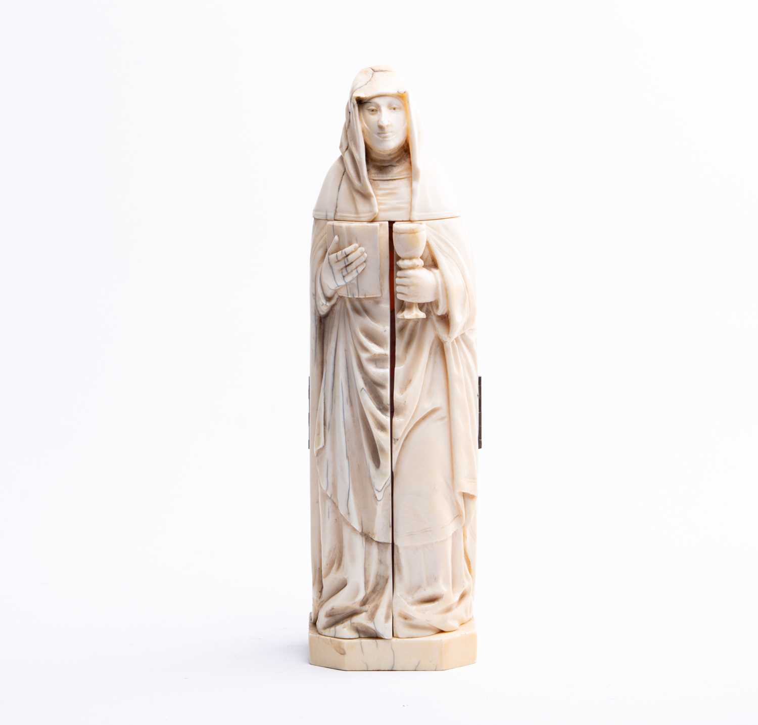 A 19th century Dieppe ivory carved triptych figure of a nun, her robes opening to reveal Classical