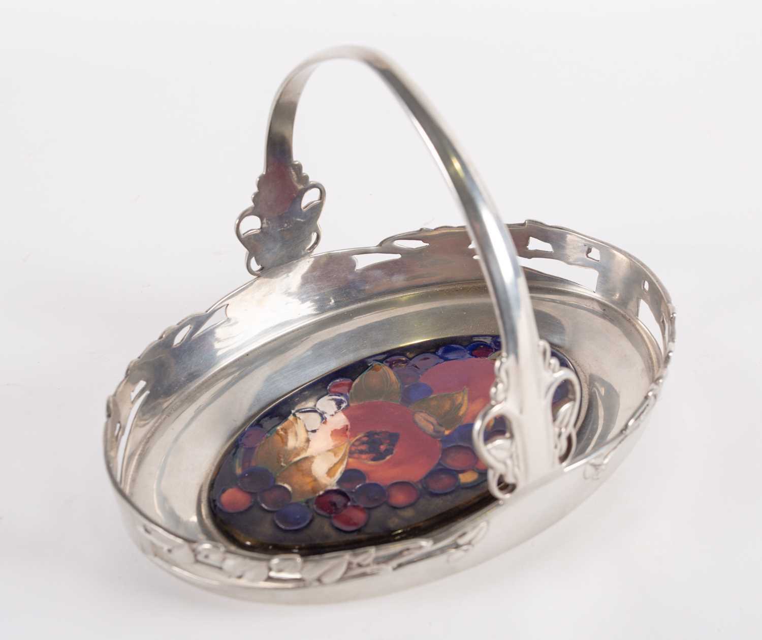 A Liberty & Co pewter loop-handled oval tray, inset with a William Moorcroft plaque, in the '