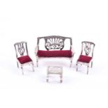 A sterling silver novelty miniature salon set, comprised of sofa, two chairs, and a table, sofa 4.