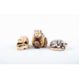 A Japanese ivory okimono and two netsukes, Meiji, the okimono carved as a wealthy young boy