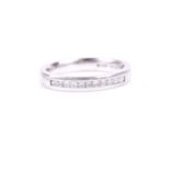 A platinum and diamond band ring, channel set with a row of square-cut diamonds, of approximately