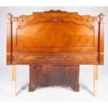 A 20th century French single bed headboard, with carved scroll decoration flanked by fluted columns,