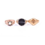 A late 19th century 9ct yellow gold and banded onyx ring, set with a shield-cut onyx plaque, with