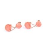 A pair of yellow metal and carved coral drop earrings, formed as a smaller and larger scallop shells