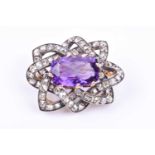 A late 19th / early 20th century diamond and amethyst brooch, centred with a mixed oval cut