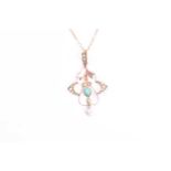 A 9ct yellow gold, seed pearl, and turquoise Art Nouveau pendant, the stylised mount suspended