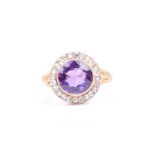 A diamond and amethyst ring, centred with a mixed round-cut amethyst, approximately 2.70 carats (8