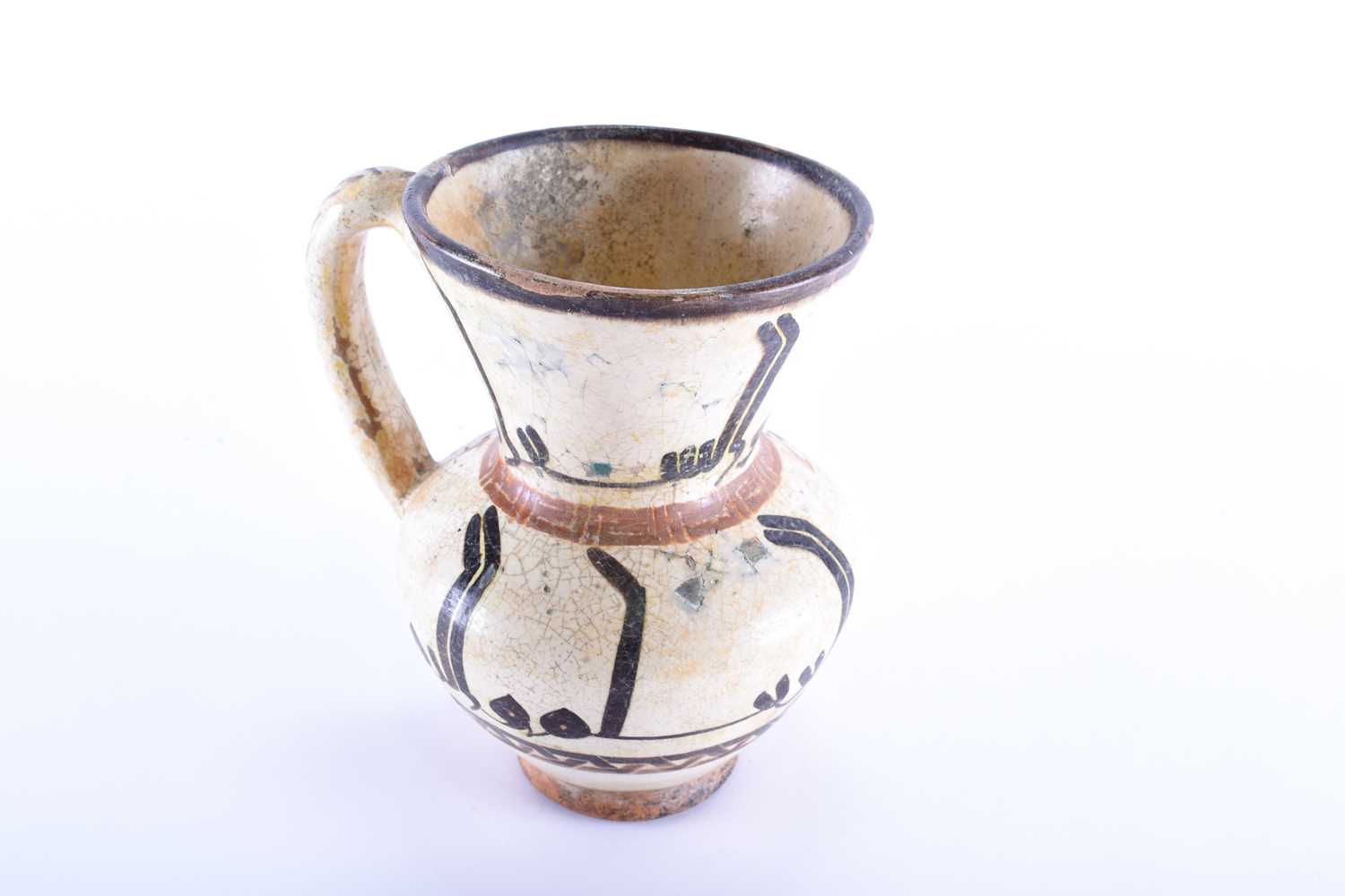 An early Islamic tin glazed ewer, with silhouette style calligraphic decoration between key and - Image 5 of 5