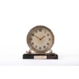 A silver plated golfing mantel clock. the circular dial with Arabic numerals in silver plated