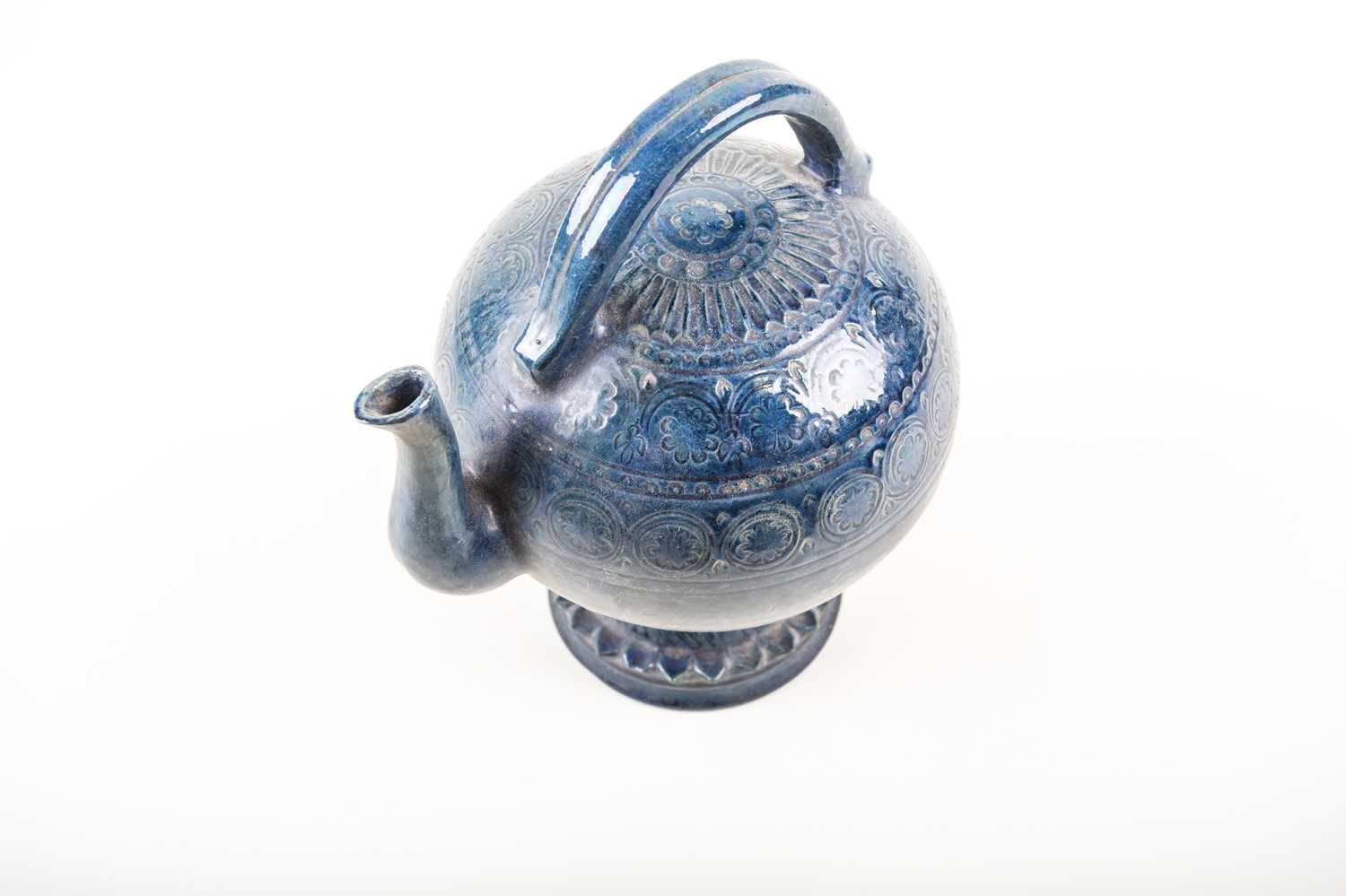 An unusual European pottery cadogan teapot, late 19th century, in a deep blue glaze with repeating - Image 2 of 4