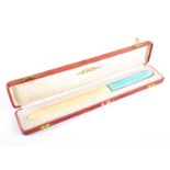 An early 20th century ivory letter opener, with pale blue guilloché enamel handle, in fitted case,
