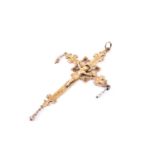 A late 19th / early 20th century yellow metal Crucifix pendant, depicting Jesus on the Cross,