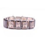 A silver and smoky quartz bracelet, the rectangular segments set with rectangular-cut quartz,