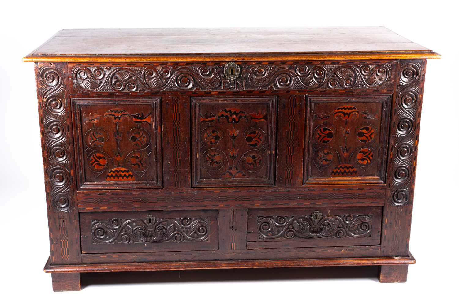 An 18th-century oak linen chest/coffer, the front with marquetry inlay and carved decoration with