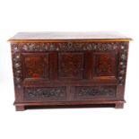An 18th-century oak linen chest/coffer, the front with marquetry inlay and carved decoration with