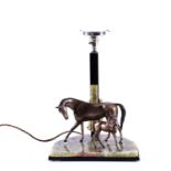 An Art Deco style equestrian-themed table lamp, modelled with a spelter mare and foal on a green