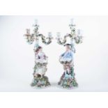 A pair of 19th century Sitzendorf porcelain figural candlesticks, modelled as a gentleman and a lady