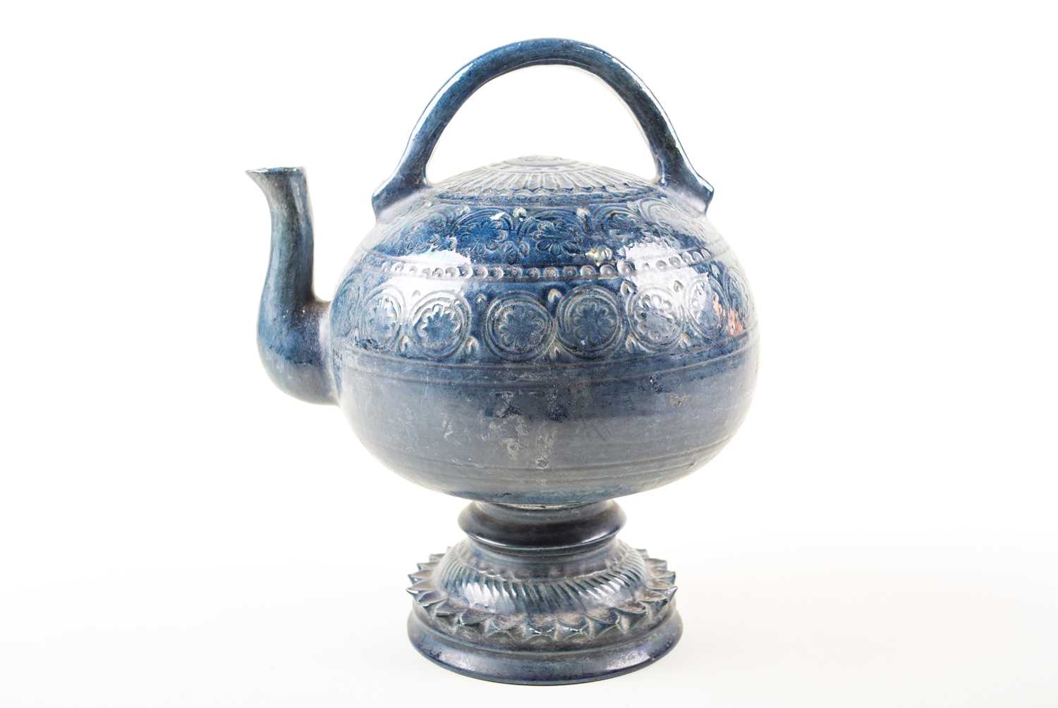 An unusual European pottery cadogan teapot, late 19th century, in a deep blue glaze with repeating