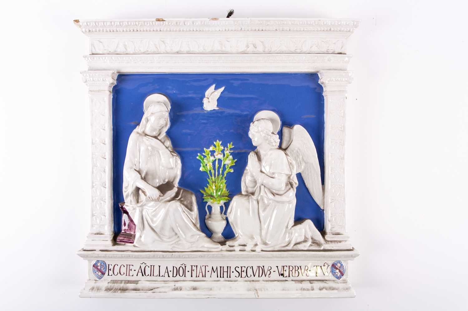 An Italian Cantagalli tin glazed wall plaque, 'The Annunciation', of rectangular form, modelled in