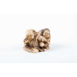 A humorous Japanese netsuke, Meiji, carved as Hyottoko and Okame, Hyottoko grimacing whilst