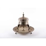 An Islamic silver plate brazier, 20th century, with domed pierced hinged cover raised on three