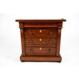 A Victorian apprentice piece miniature chest of drawers, the plain top over a concealed cushion