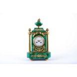 A French Empire style malachite and ormolu mounted mantle clock, with white circular enamel dial