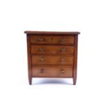 A late 19th/early 20th century apprentice chest of drawers, comprising four long drawers with inlaid