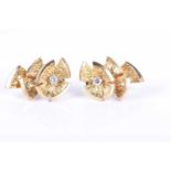 Cartier. A pair of 18ct yellow gold and diamond clip earringsof floral design, each inset with a