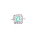 A platinum, diamond, and emerald ring, set with a mixed square-cut emerald of approximately 0.85