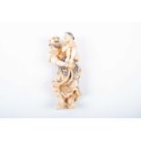 A Japanese ivory netsuke, late Meiji/Taisho, carved as a man holding a young boy in his arms, the