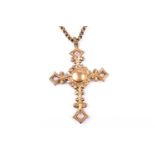 A 19th century yellow metal Cross pendant, of ornate design, the stylised mount inset with a round