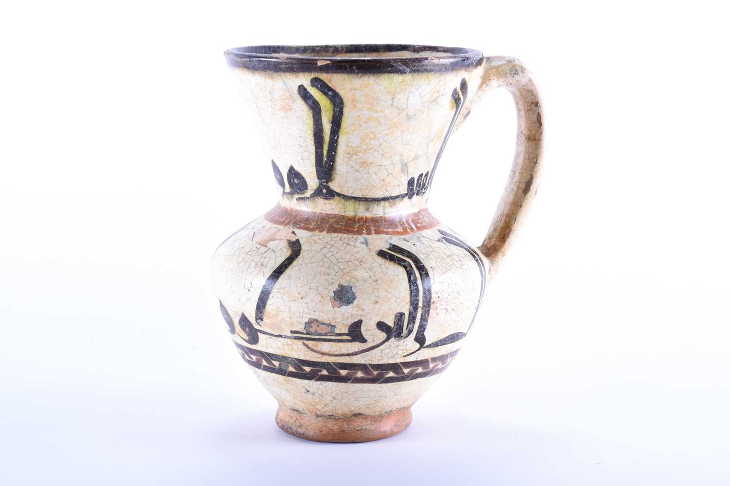 An early Islamic tin glazed ewer, with silhouette style calligraphic decoration between key and