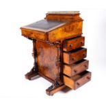 A Victorian figured walnut Davenport, the top with stationery compartment and folding writing