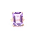 A yellow metal and amethyst ring, the wrythen mount with twisted shank and four-claw setting, with a